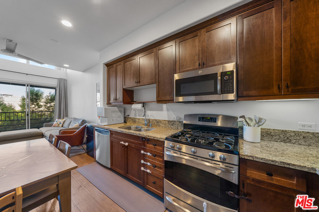 629 Traction Avenue, Unit 233 Los Angeles, CA 90013 - Photo 3 of 41 a kitchen with stainless steel appliances granite countertop a stove microwave and sink