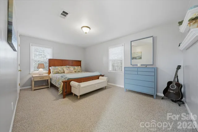 a spacious bathroom with a granite countertop sink a toilet and a mirror