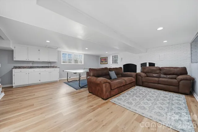 a living room with furniture a flat screen tv and a table