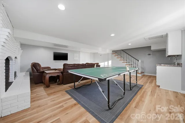 a living room with furniture a rug and a table