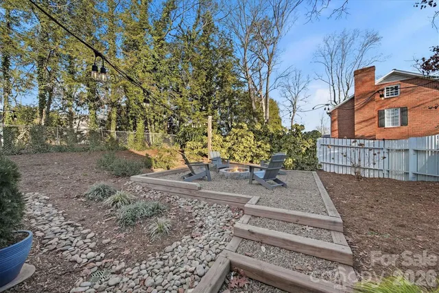 a view of a house with backyard sitting area and garden