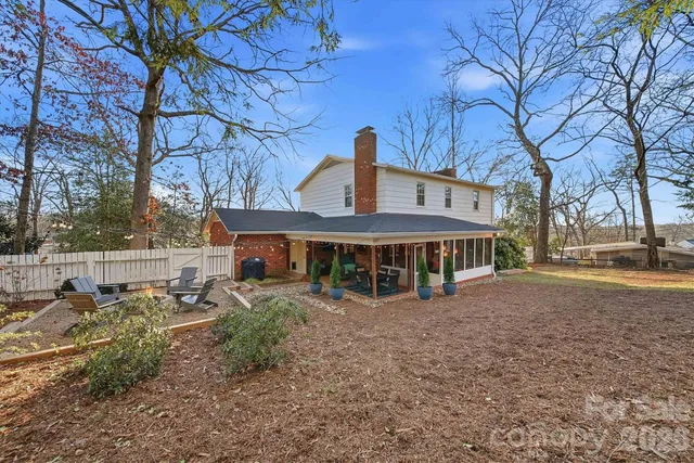 a view of a house with backyard and sitting area