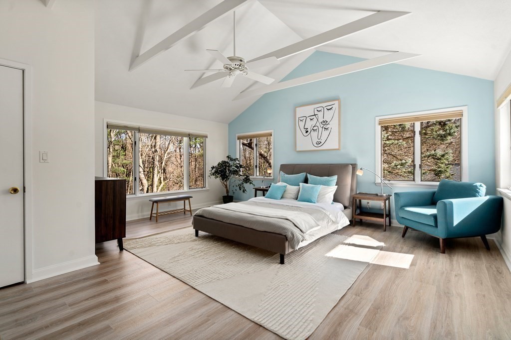 24 Flintlock Road Lexington, MA 02420 - Photo 16 of 33 a spacious bedroom with a bed a couch and a window