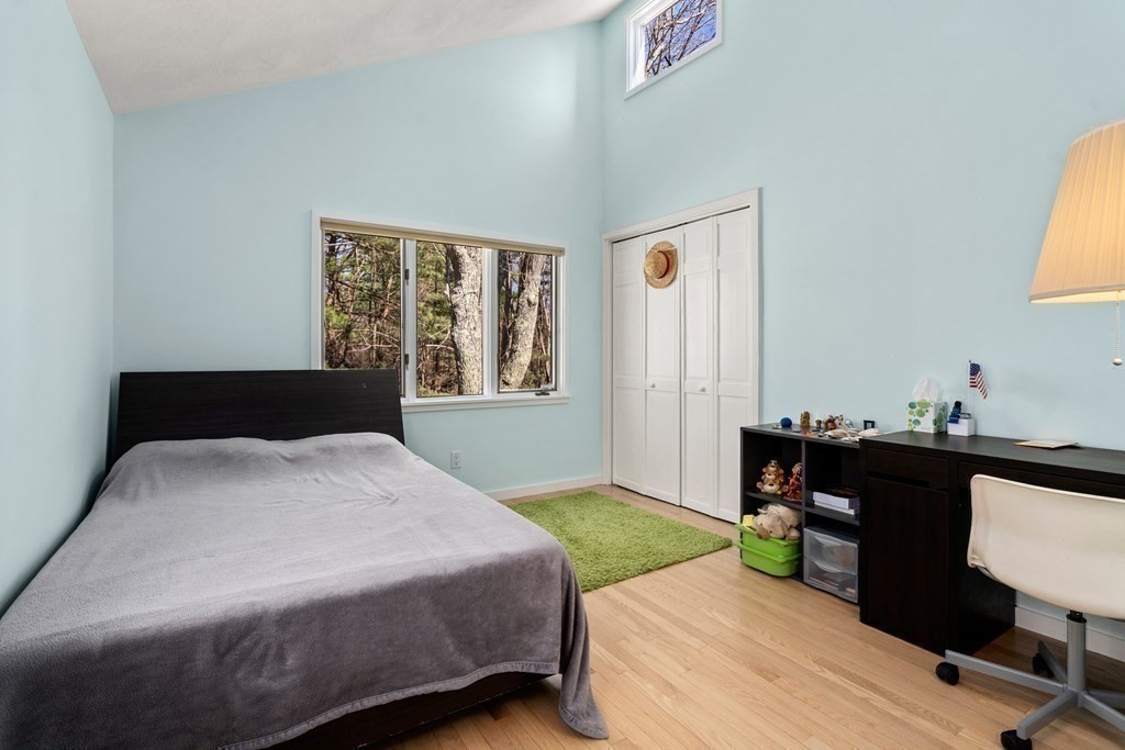 24 Flintlock Road Lexington, MA 02420 - Photo 18 of 33 a bedroom with a bed and a table in it