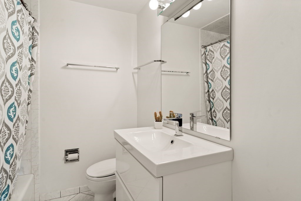 24 Flintlock Road Lexington, MA 02420 - Photo 20 of 33 a bathroom with a sink toilet and mirror