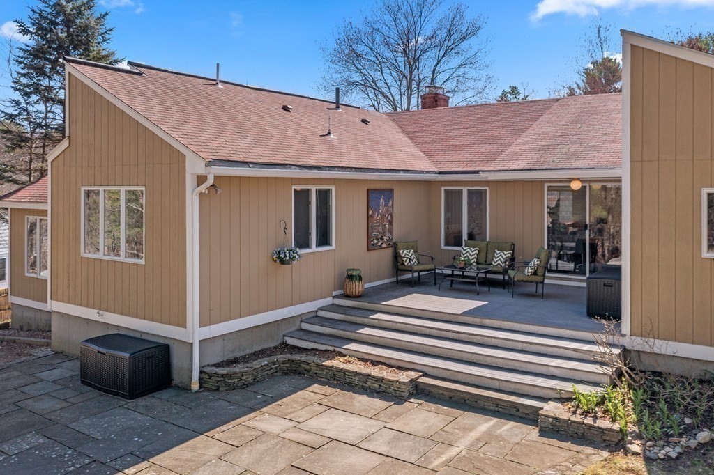 24 Flintlock Road Lexington, MA 02420 - Photo 28 of 33 a view of a house with backyard and sitting area