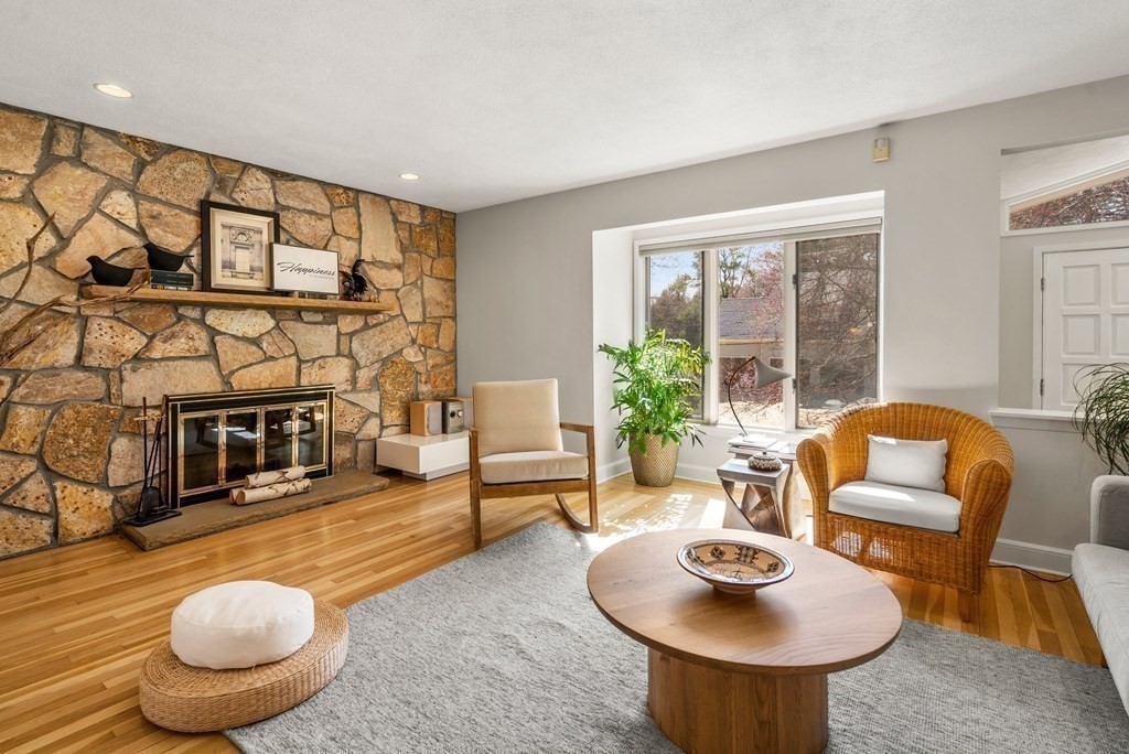 24 Flintlock Road Lexington, MA 02420 - Photo 9 of 33 a living room with furniture and a fireplace