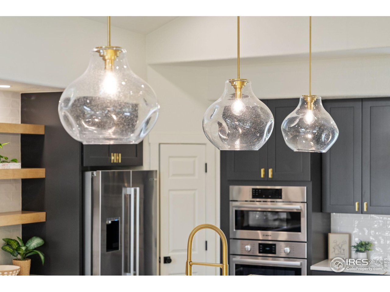 5304 Vardon Way Fort Collins, CO 80528 - Photo 13 of 47 a kitchen with furniture a chandelier and stainless steel appliances