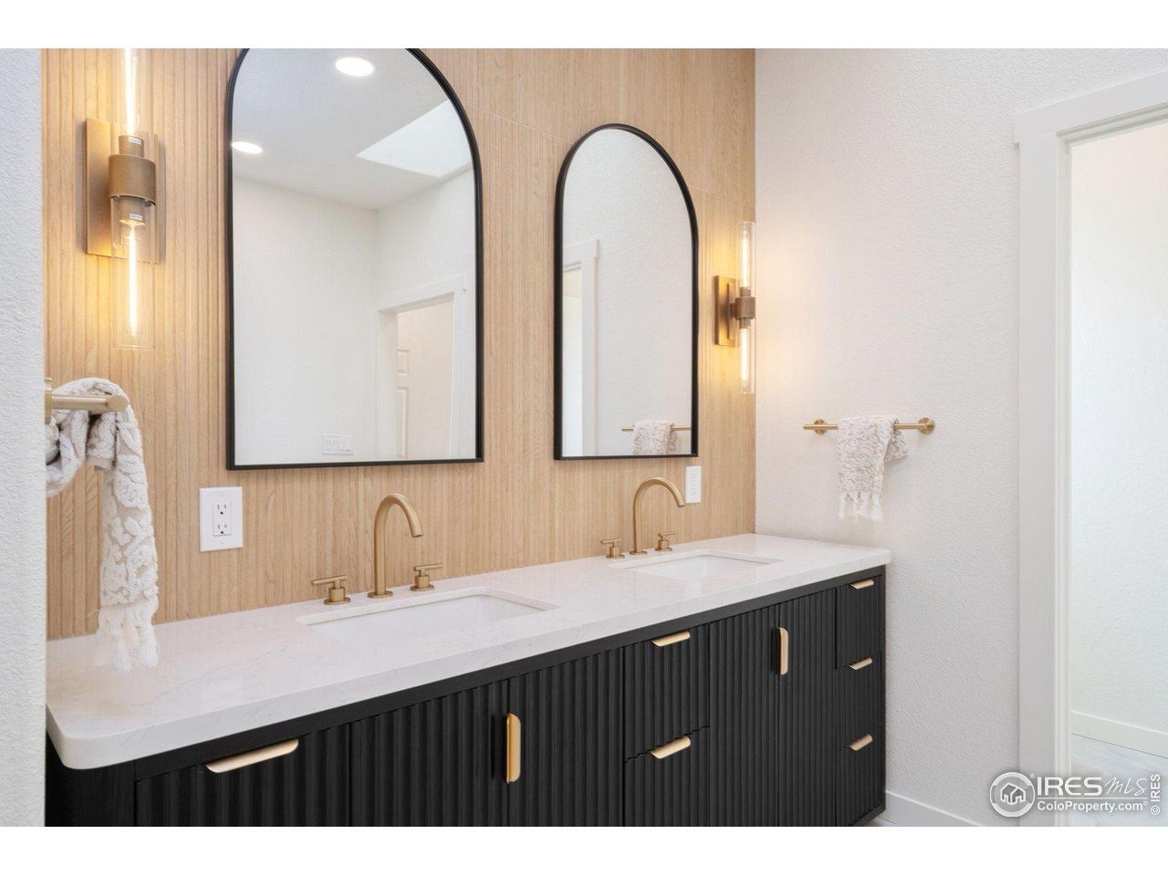 5304 Vardon Way Fort Collins, CO 80528 - Photo 22 of 47 a bathroom with a double vanity sink and a mirror