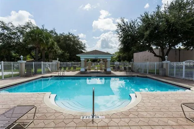 a view of a swimming pool with a patio