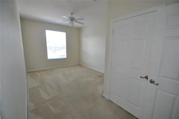 a view of an empty room and a window