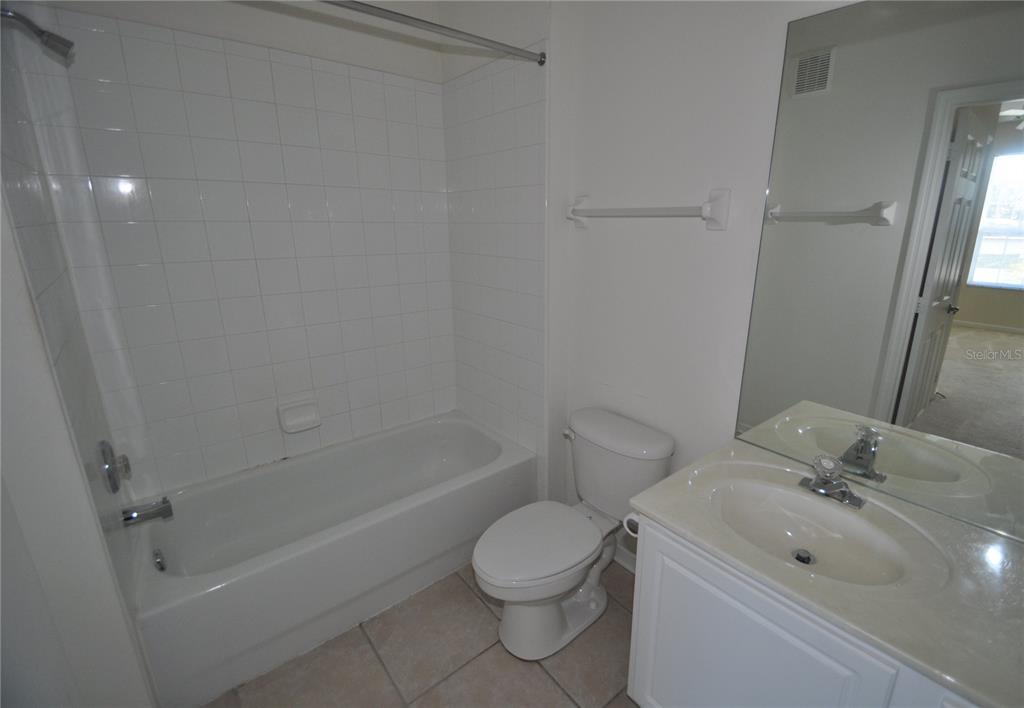 588 Brantley Terrace Way, Unit 305 Altamonte Springs, FL 32714 - Photo 5 of 13 a bathroom with a sink toilet and shower
