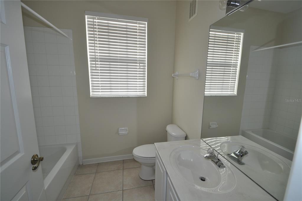 588 Brantley Terrace Way, Unit 305 Altamonte Springs, FL 32714 - Photo 7 of 13 a bathroom with a sink a toilet and shower
