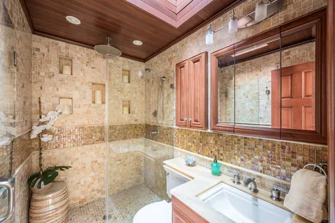 a living room with furniture a chandelier and a dining table