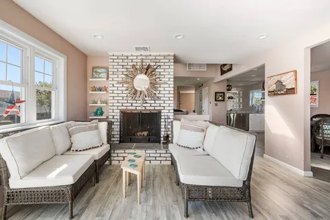 a room with wooden floor and pool table