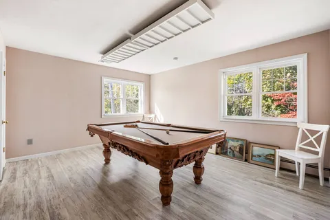 a dining room with furniture and wooden floor