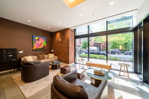 a living room with furniture and a floor to ceiling window
