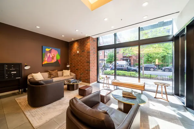 a living room with furniture and a floor to ceiling window