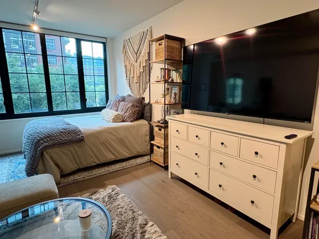 a bedroom with furniture and a flat screen tv