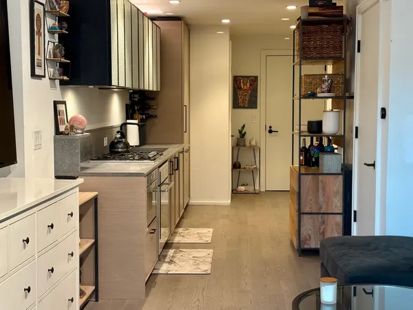 a kitchen with stainless steel appliances granite countertop a stove a refrigerator and a cabinets