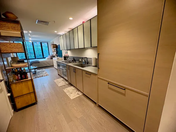 a kitchen with stainless steel appliances granite countertop a refrigerator and a stove top oven