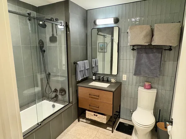a bathroom with a sink toilet and shower
