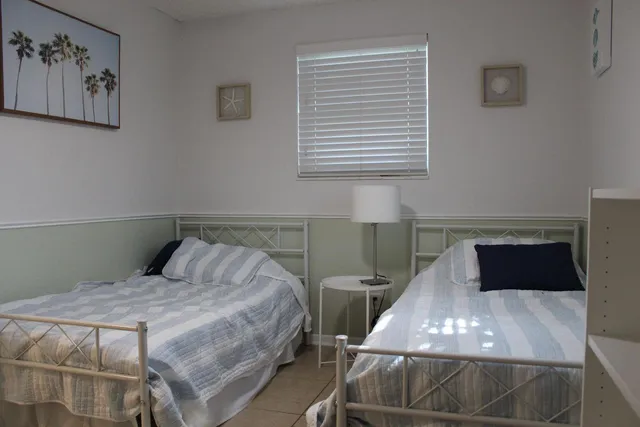 a bedroom with a bed and the view of kitchen
