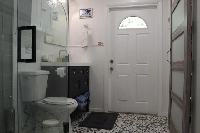 a bathroom with a toilet a sink and mirror
