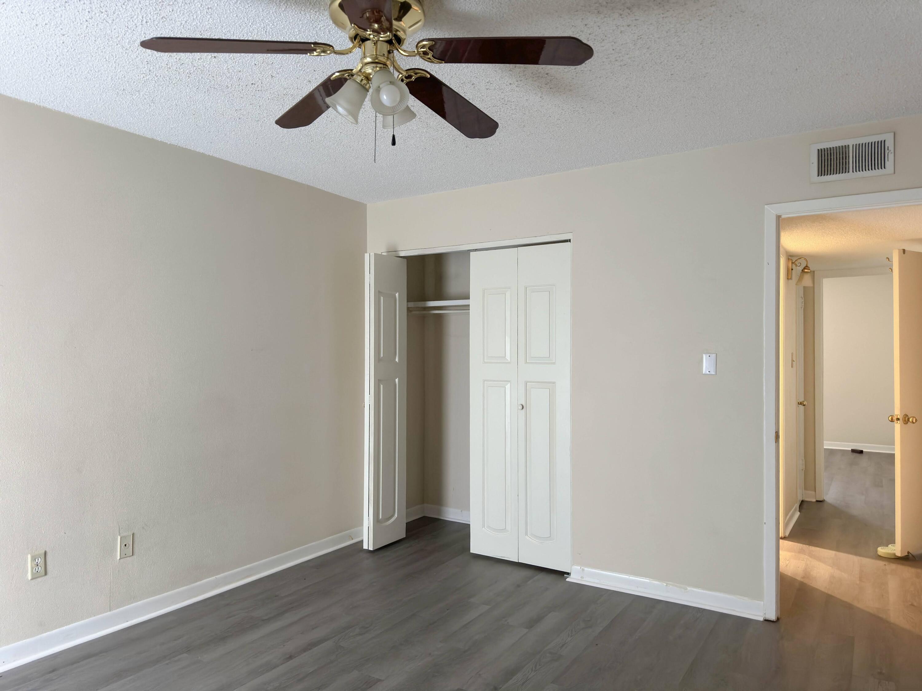 210 Pelham Road, Unit 103B Fort Walton Beach, FL 32547 - Photo 14 of 19 an empty room with closet and a ceiling fan