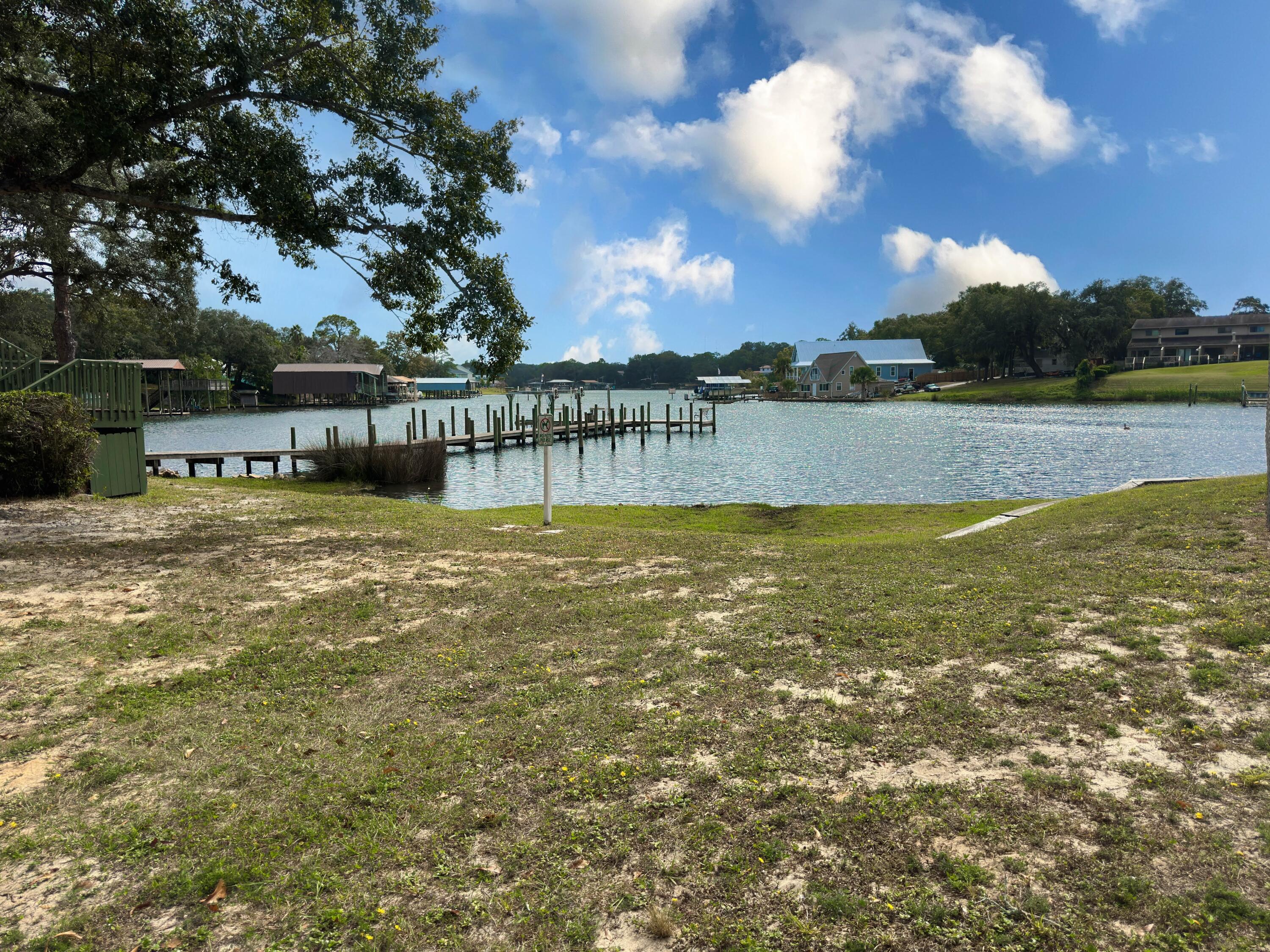 210 Pelham Road, Unit 103B Fort Walton Beach, FL 32547 - Photo 15 of 19 a view of a lake with houses in the background