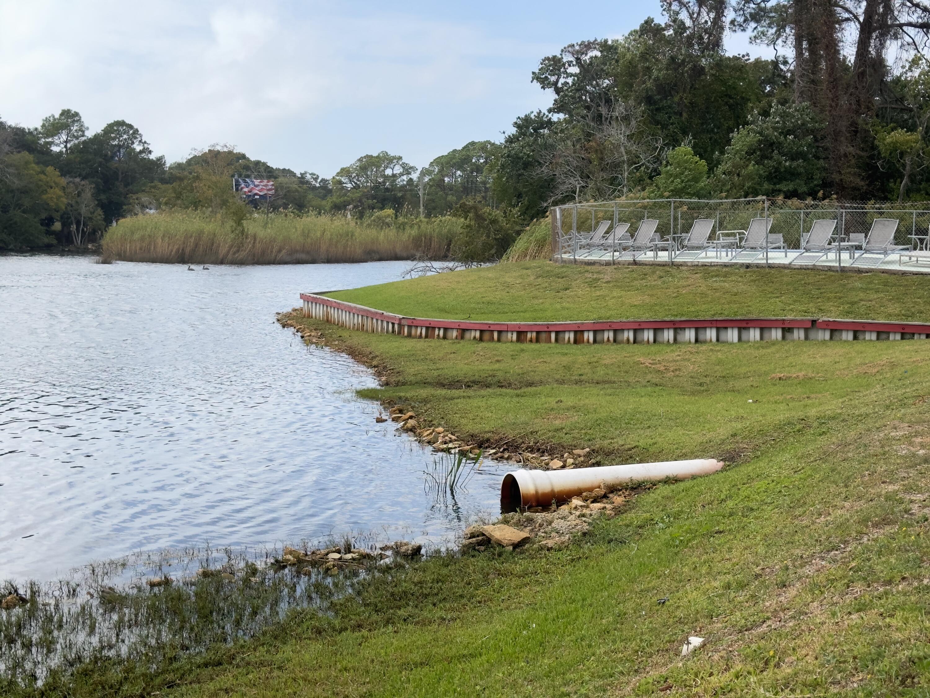 210 Pelham Road, Unit 103B Fort Walton Beach, FL 32547 - Photo 19 of 19 a view of a water pond with green field