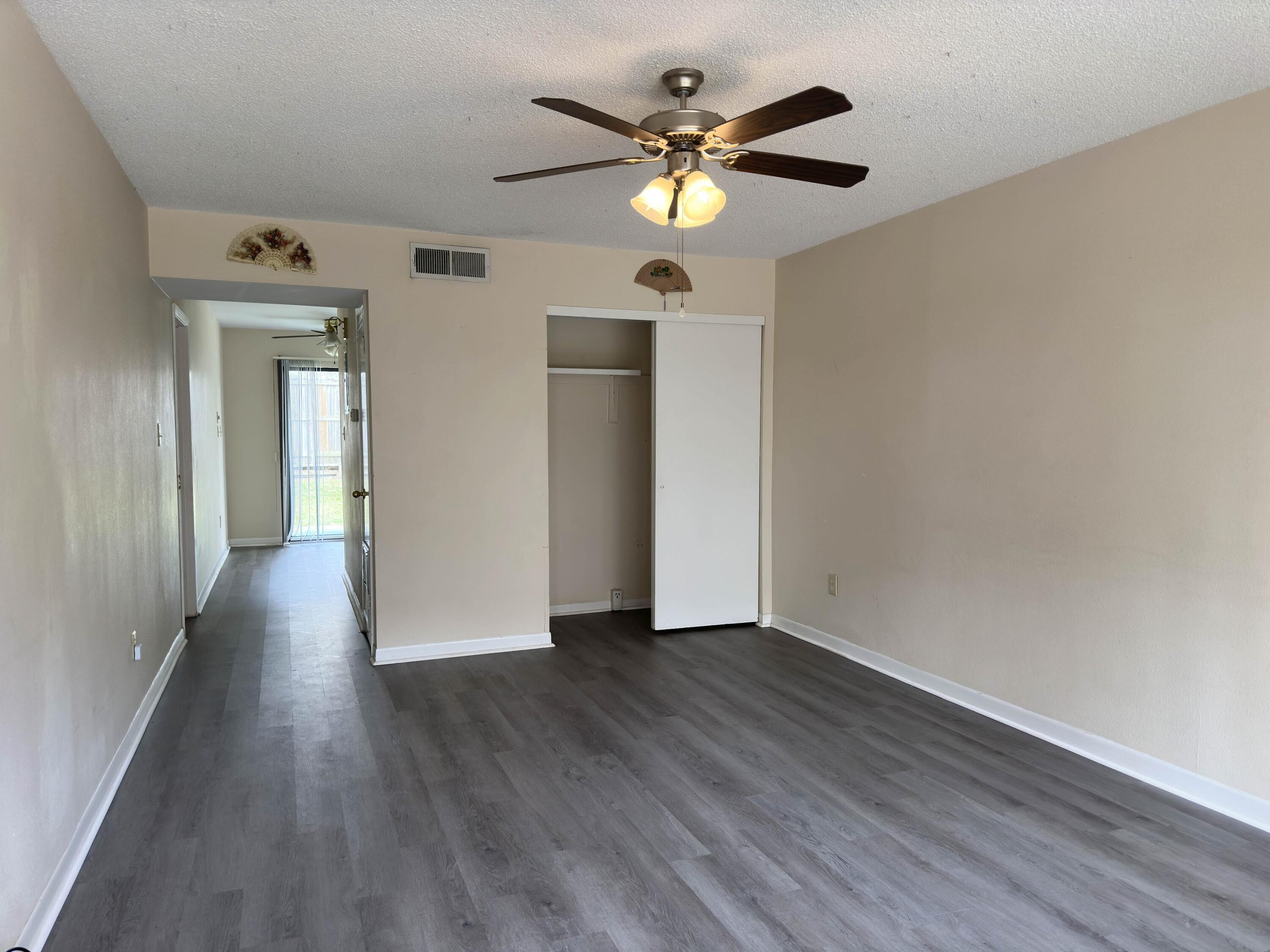 210 Pelham Road, Unit 103B Fort Walton Beach, FL 32547 - Photo 3 of 19 a view of an empty room with wooden floor