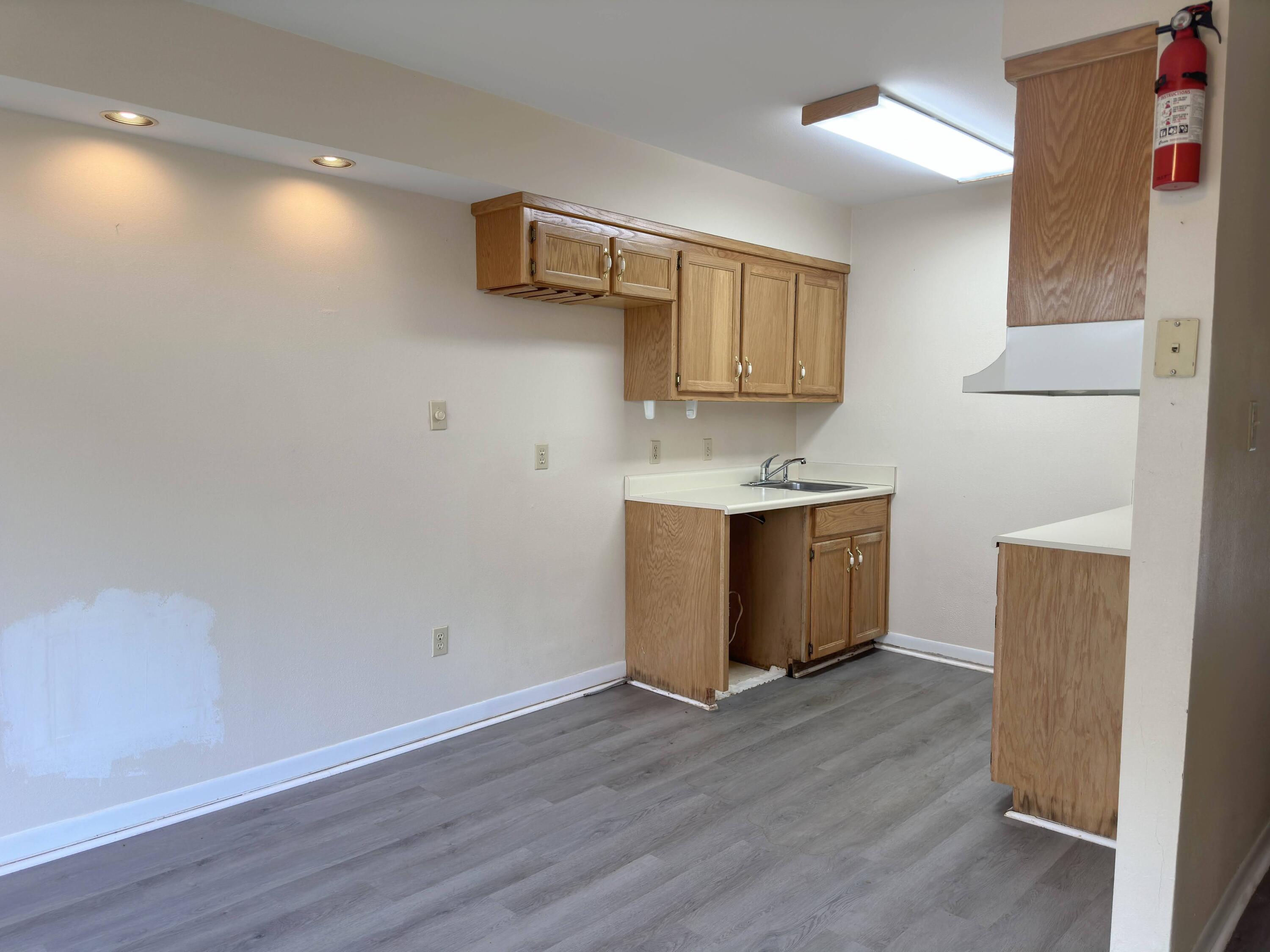 210 Pelham Road, Unit 103B Fort Walton Beach, FL 32547 - Photo 7 of 19 a room with wooden floor and window