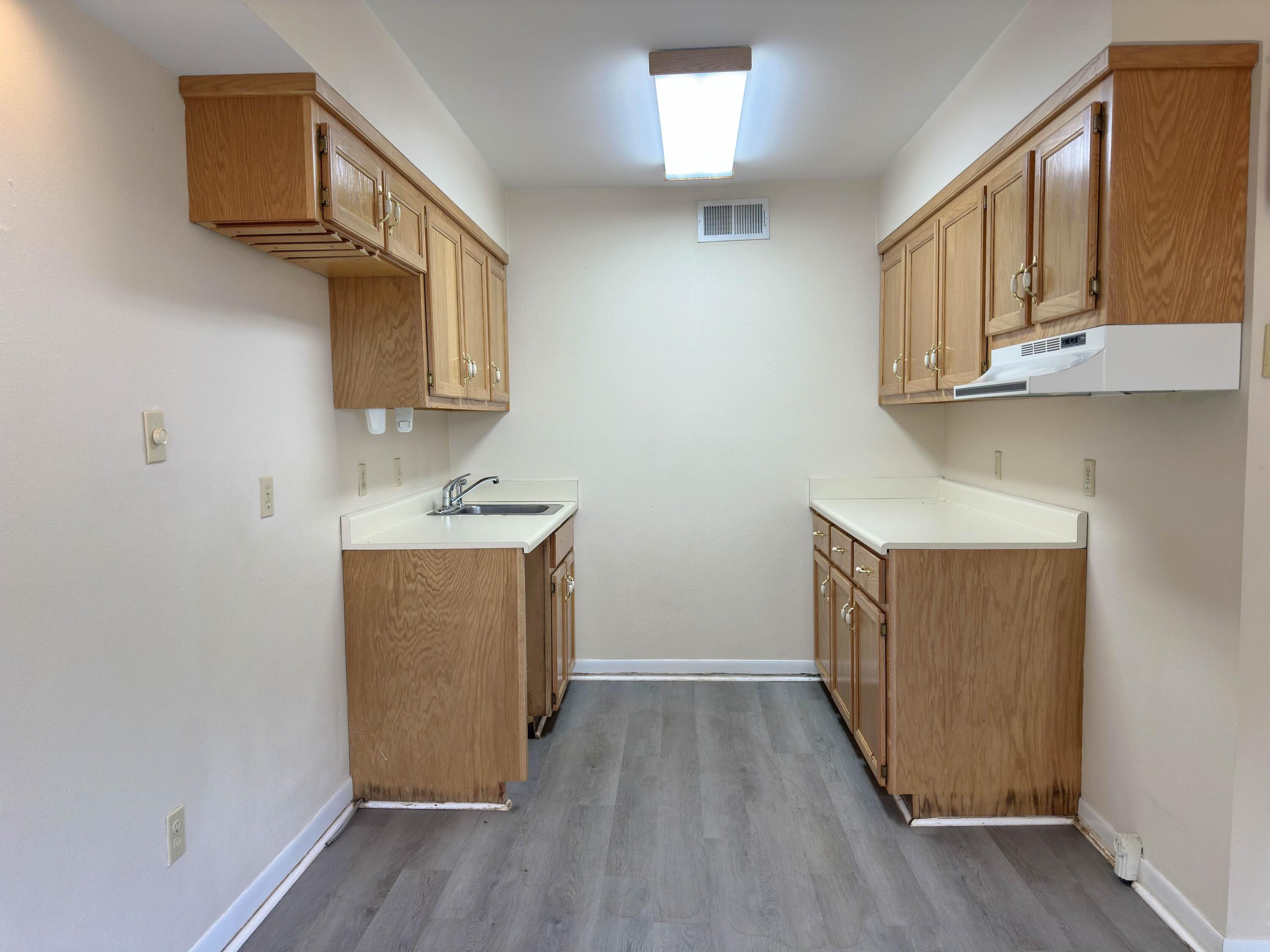 210 Pelham Road, Unit 103B Fort Walton Beach, FL 32547 - Photo 8 of 19 a view of hallway with wooden floor