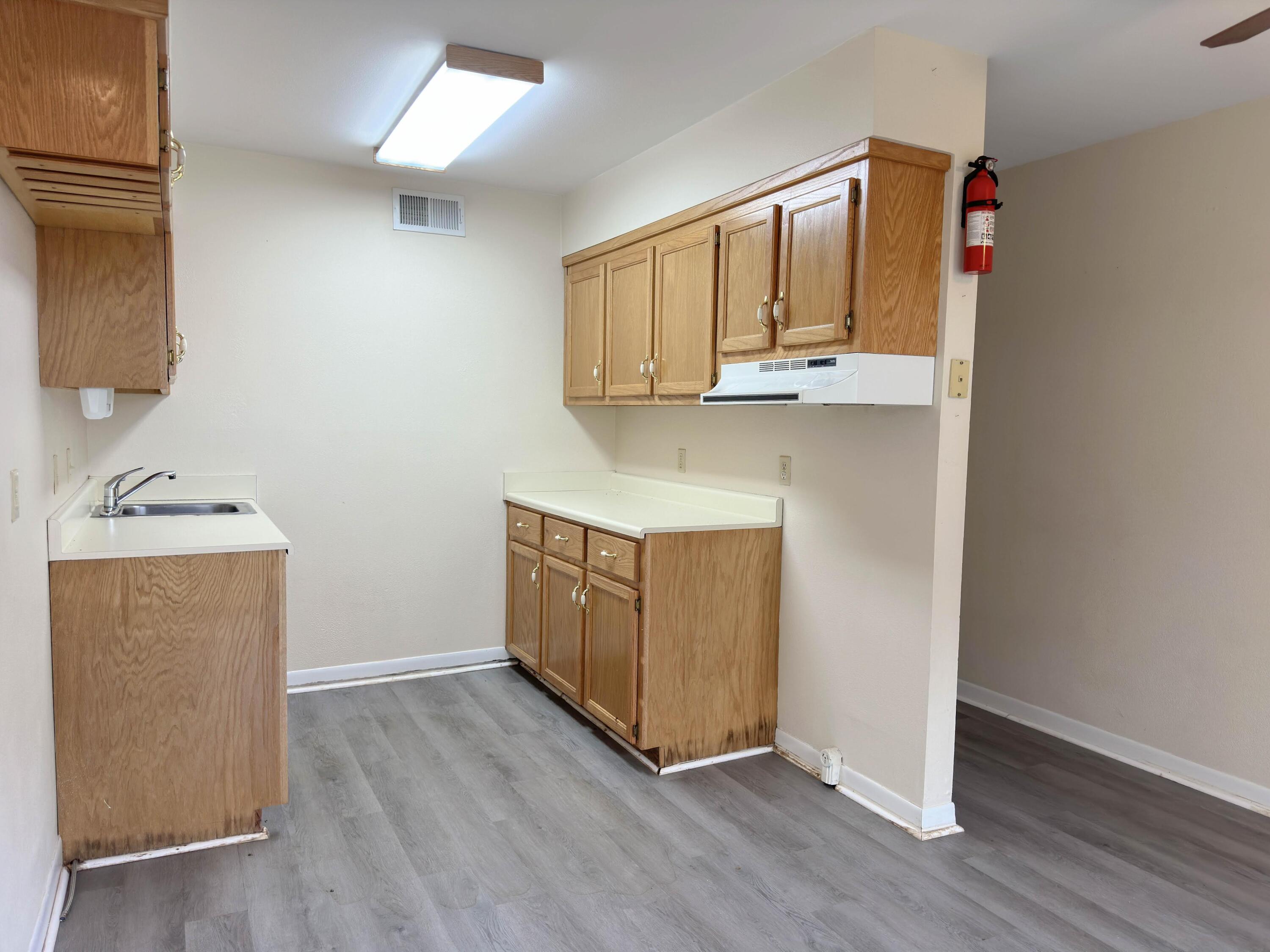 210 Pelham Road, Unit 103B Fort Walton Beach, FL 32547 - Photo 9 of 19 a view of an empty room and wooden floor