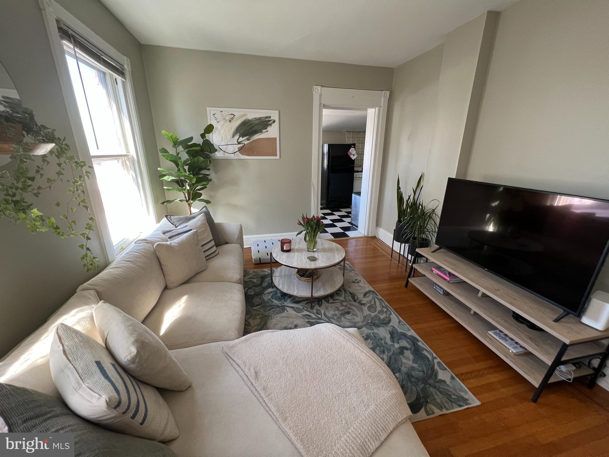 337 West Union Street, Unit 5 West Chester, PA 19382 - Photo 5 of 9 a living room with furniture and a flat screen tv