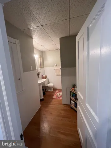 a view of a hallway to a livingroom and a couch