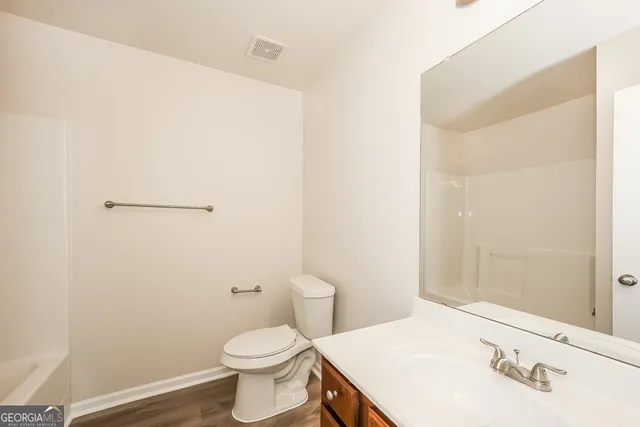 a bathroom with a sink a toilet and vanity