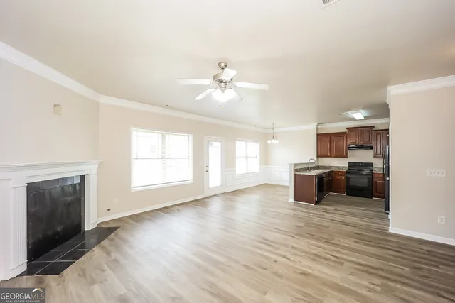 a view of a kitchen with a stove cabinets and wooden floor