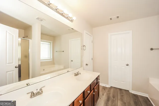 a bathroom with a sink a mirror and a shower