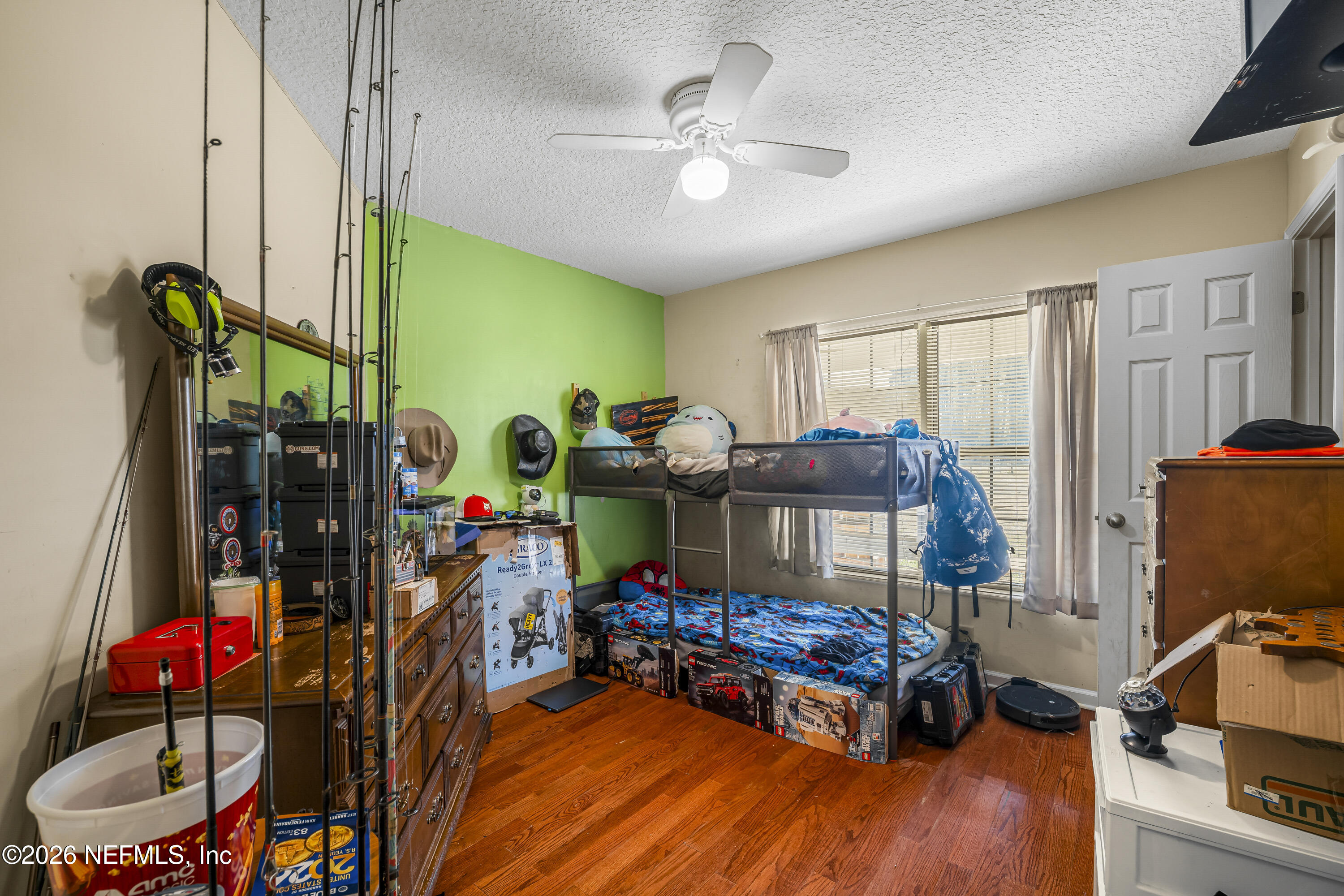 1725 Davidson Farm Road Jacksonville, FL 32218 - Photo 37 of 53 a bedroom with furniture and a chandelier