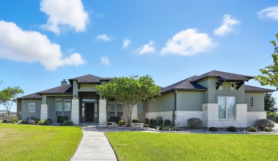 8658 KIng Ranch Drive Corpus Christi, TX 78414 - Photo 1 of 40 a front view of a house with a yard table and chairs