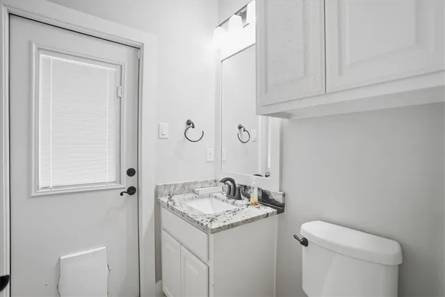 a bathroom with a sink toilet and vanity
