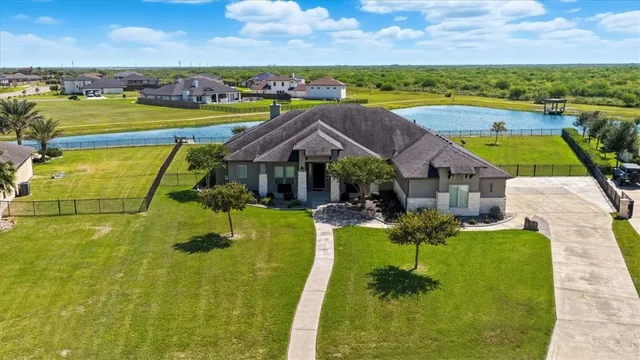 a view of house with garden space and ocean view