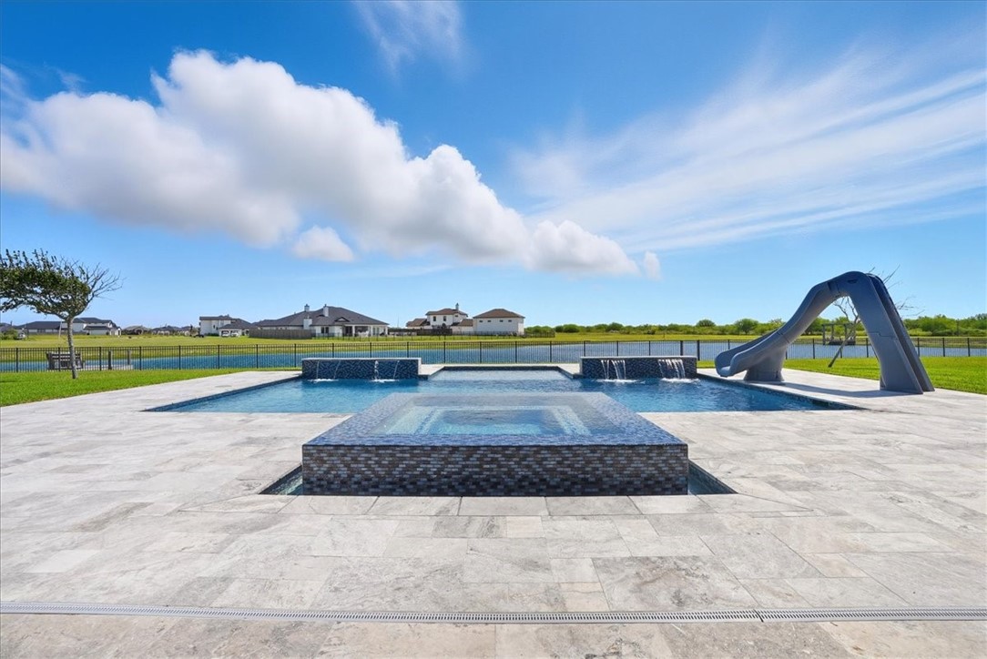 8658 KIng Ranch Drive Corpus Christi, TX 78414 - Photo 35 of 40 a view of swimming pool with a garden and fire pit
