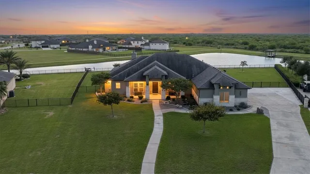 an aerial view of a house with garden space and ocean view