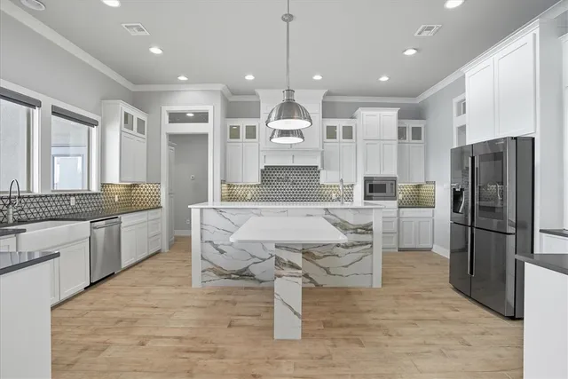 a large kitchen with a table and chairs
