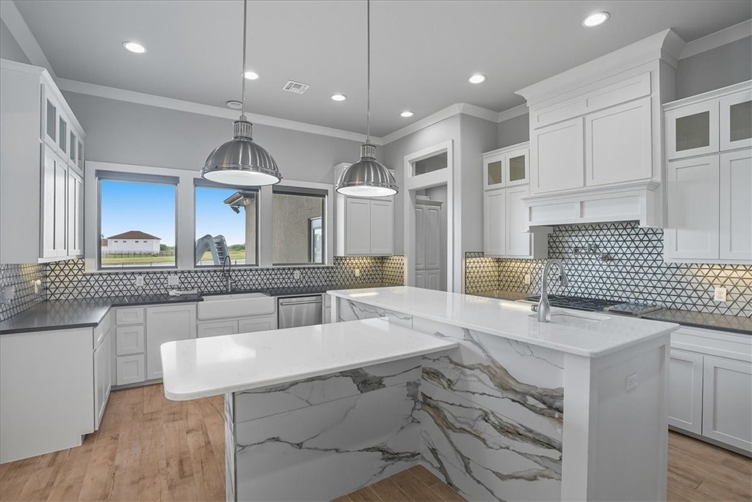 8658 KIng Ranch Drive Corpus Christi, TX 78414 - Photo 10 of 40 a kitchen with kitchen island granite countertop a sink cabinets and window