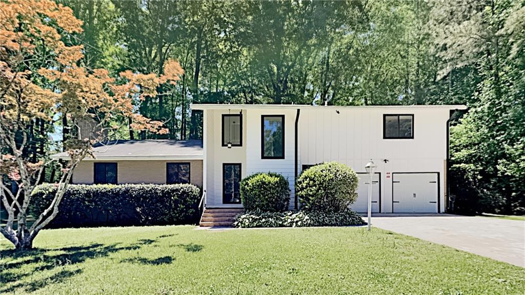 5145 Kerry Drive Southwest Atlanta, GA 30331 - Photo 1 of 1 a front view of a house with a yard and garage