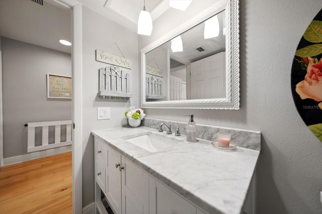 2515 Bay Boulevard, Unit B Indian Rocks Beach, FL 33785 - Photo 24 of 66 a bathroom with a granite countertop sink and a mirror